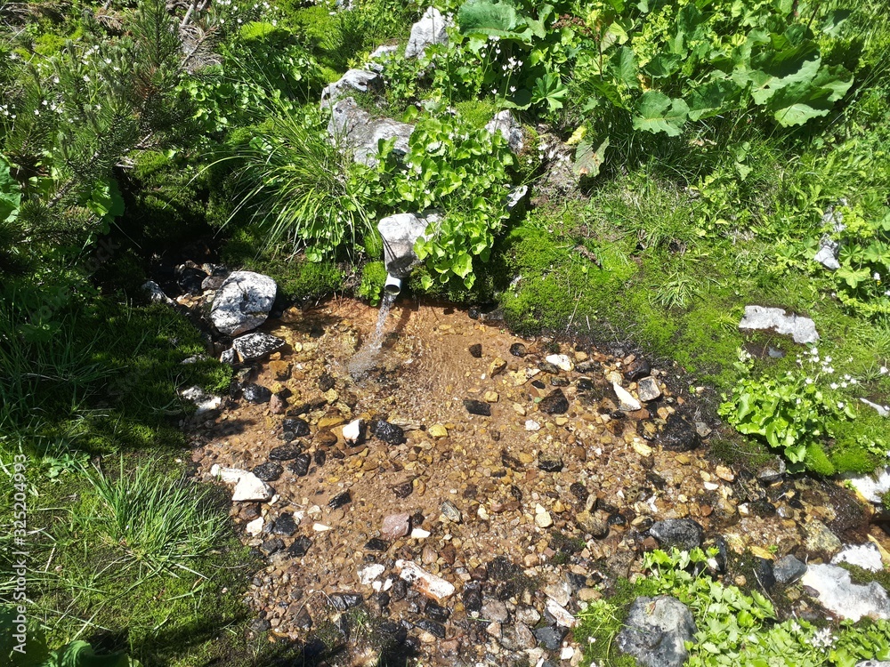 Small water well hidden in the mountains