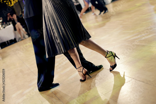 Graceful lines of legs of Argentina tango dancers