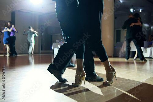 Graceful lines of legs of Argentina tango dancers
