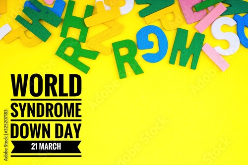 WORLD SYNDROME DOWN DAY text with ABC wooden letters alphabet scattered on a yellow background. Education and copy space
