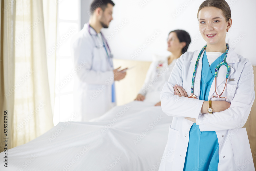 Doctors and nurses stacking hands. Isolated on white Doctors and nurses stacking hands. Isolated on white