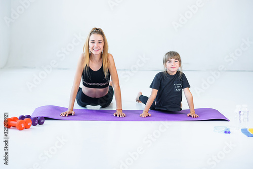 children practicing are engaged in gymnastics and yoga with teacher