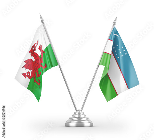 Uzbekistan and Wales table flags isolated on white 3D rendering