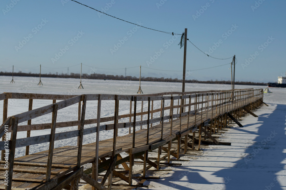 ship breaks ice on a frozen river for other ships.