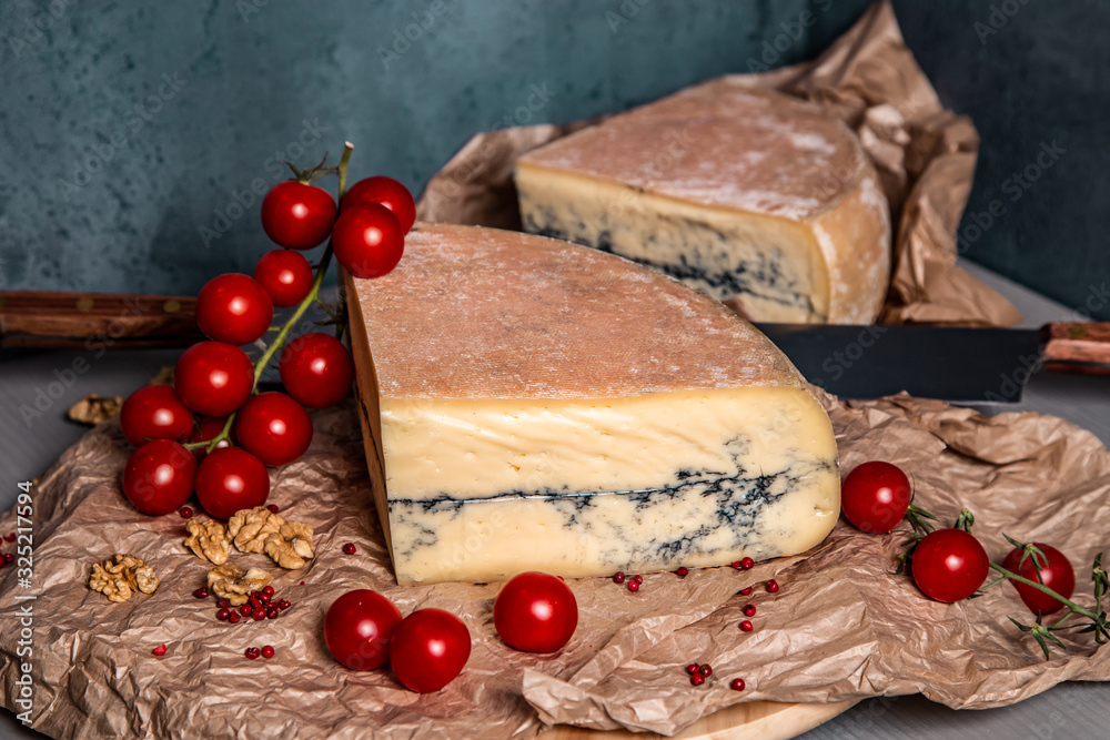 Garganzola cheese and cherry tomatoes on a blue background