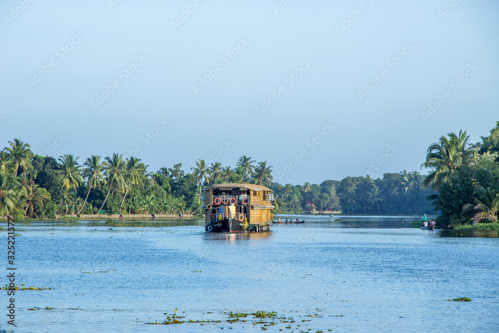 A shot of Wooden boat house floating in Alleppey waters A shot of Wooden boat house floating in Alleppey waters