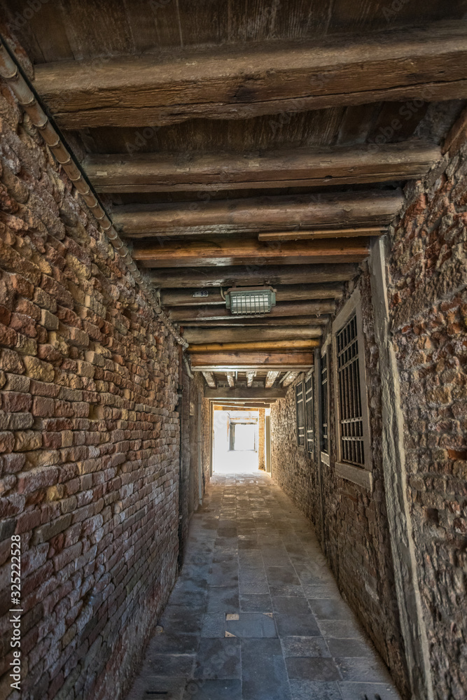 VENICE, ITALY - August 03, 2019: Narrow pedestrian streets of Venice bitween the channels. Some quiet places almost without people