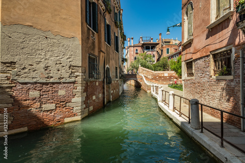 VENICE, ITALY - August 03, 2019: Narrow pedestrian streets of Venice bitween the channels. Some quiet places almost without people photo