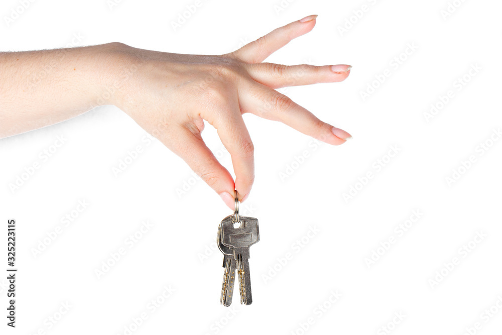 House keys in the female hand on a white background House keys in the female hand on a white background