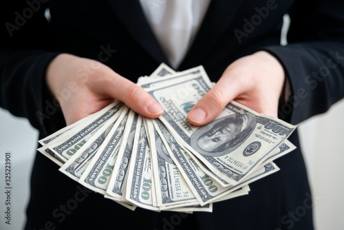 Woman counting dollar bills