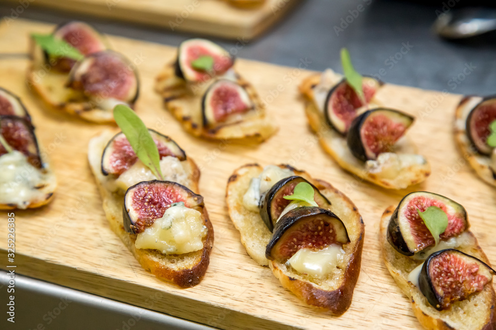 toast with brie cheese and figs on a wooden board toast with brie cheese and figs on a wooden board