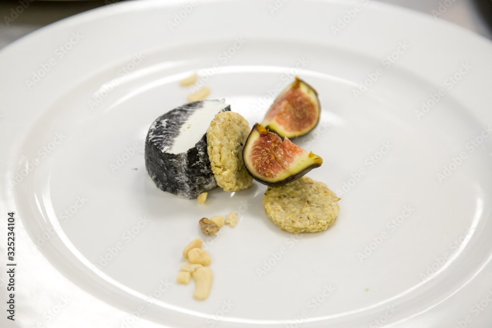 figs and cheese with honey on a white plate figs and cheese with honey on a white plate