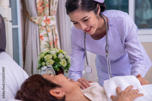 Young nurse take care senior woman on a bed, A nurse checking sernior  woman, Senior woman happniess and smiling with nurse, Health care concept photo