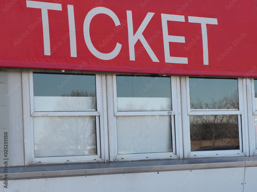 Closed ticket box office windows under big red sign Closed ticket box office windows under big red sign