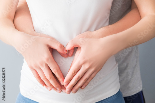 Wallpaper Mural Pregnant woman and her husband hugging the tummy Torontodigital.ca