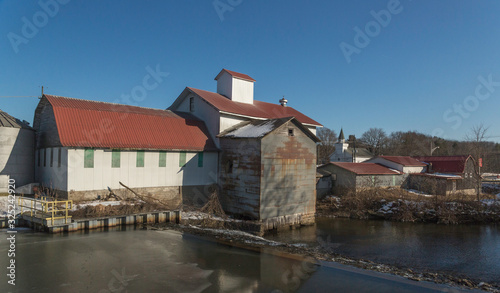 old feed mill in Pennsylvania with the lake and clear skies 