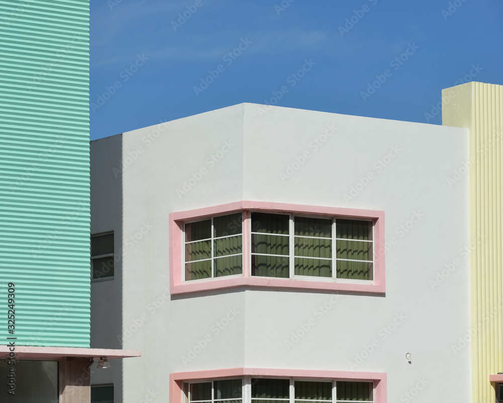 Tropical Art Deco architecture. Pastel colors, geometric patterns and corrugated wall texture against clear blue sky.