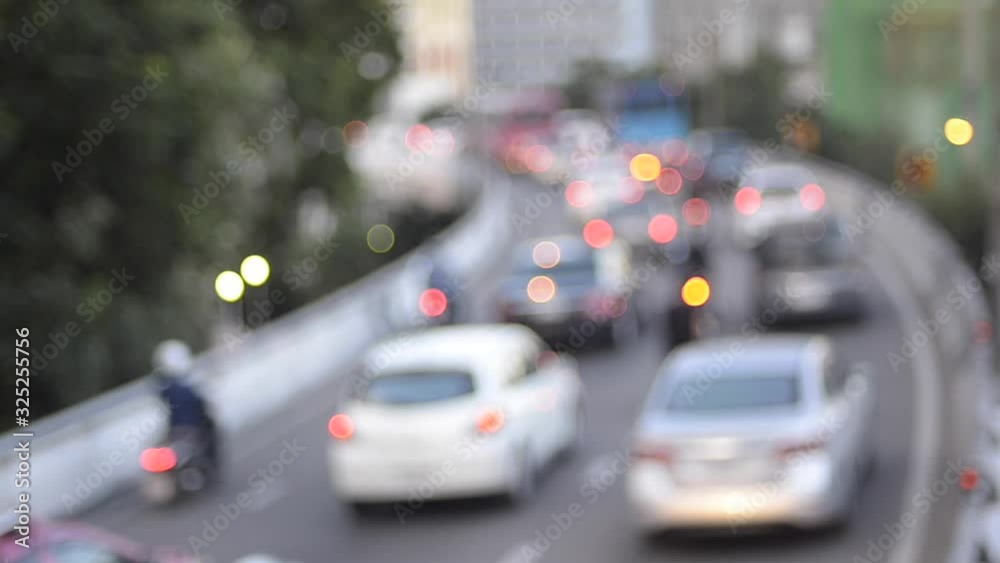 POV beautiful glittering bokeh in blurry background of traffic jam. The round colorful bokeh shine from car lights in traffic jam in city street. Abstract concept transportation. Abstract background. POV beautiful glittering bokeh in blurry background of traffic jam. The round colorful bokeh shine from car lights in traffic jam in city street. Abstract concept transportation. Abstract background.