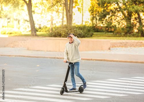 Young man riding electric s...