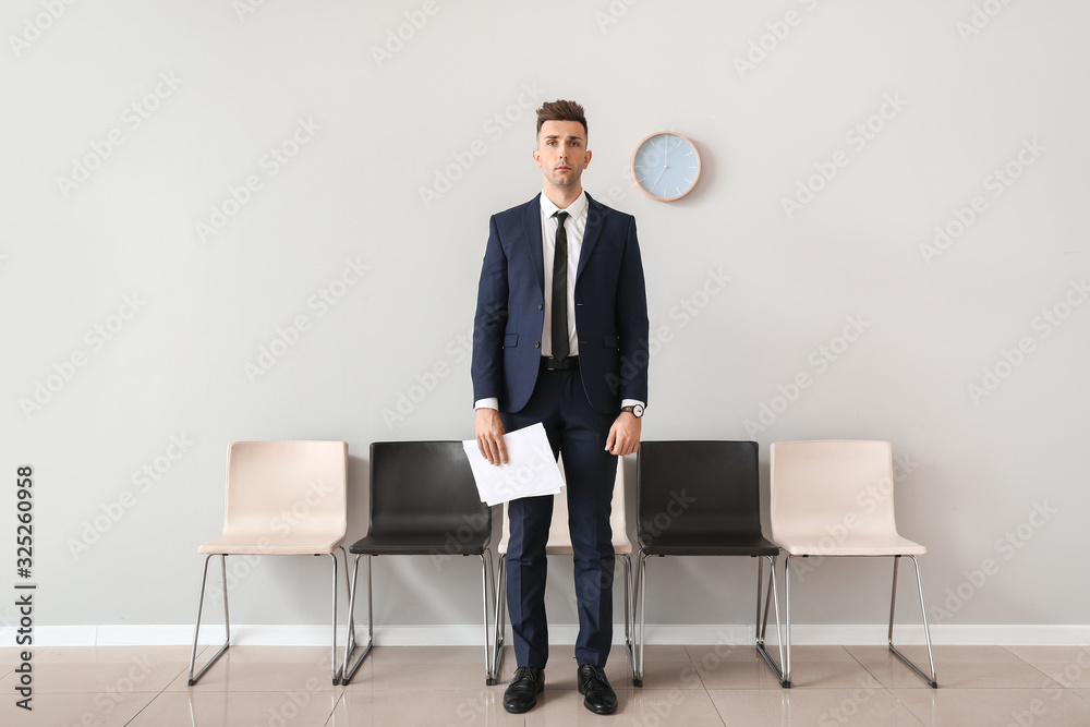 Young man waiting for job interview indoors Young man waiting for job interview indoors