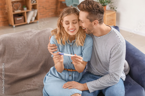 Happy young couple with pre...