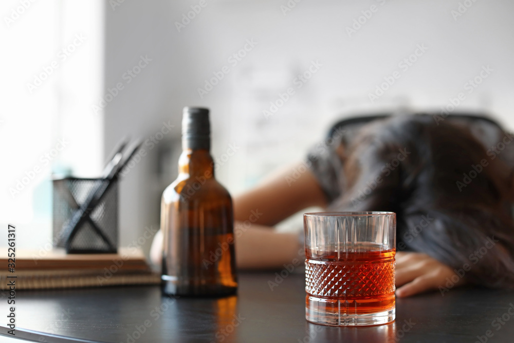 Young drunk woman in office. Concept of alcoholism Young drunk woman in office. Concept of alcoholism