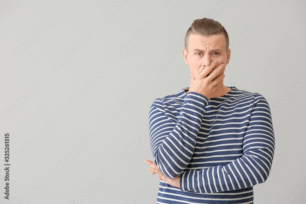 Worried young man on light background Worried young man on light background