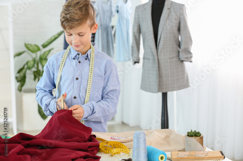 Cute little tailor working ...