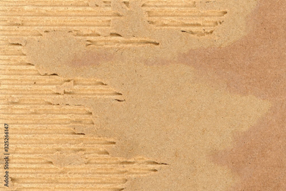 ripped damaged corrugated cardboard background, shredded brown paper ...