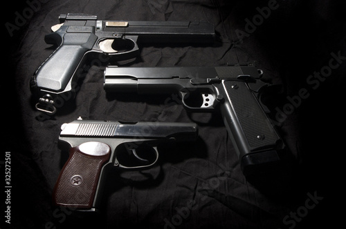 Air pistols on a black background