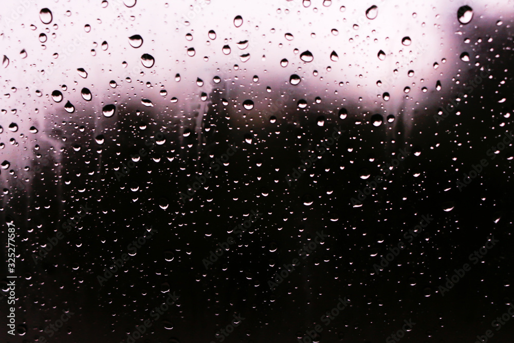 Textures of water droplets of rain flow down the windowpane. Rain drop on the car glass background, Blurred photo, Soft focus