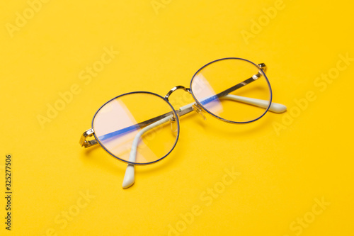 Eye glasses isolated on yellow background.