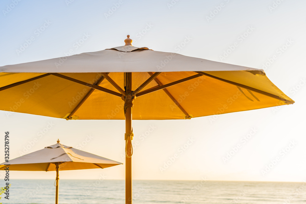 Umbrella and chair around beach sea ocean at sunset or sunrise time