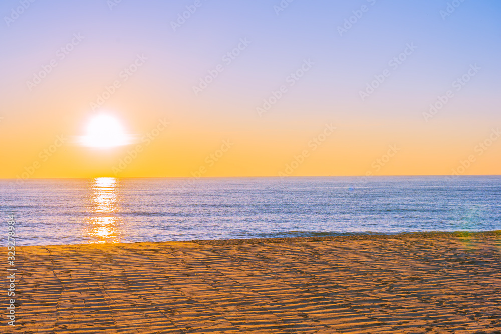 Beautiful tropical beach sea ocean with sunset or sunrise for travel vacation