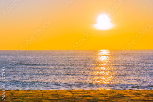 Beautiful tropical beach sea ocean with sunset or sunrise for travel vacation