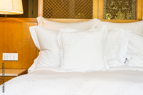Comfortable white pillow on bed decoration in bedroom