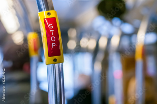 Fotografie Stop button inside a bus with braille markings