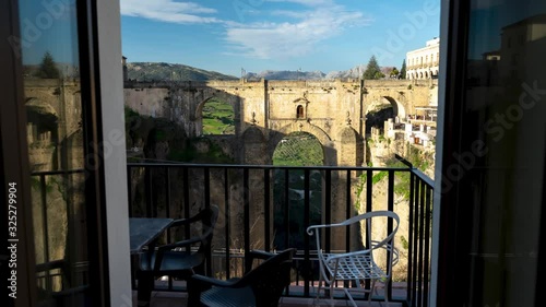 Ronda balcony window view of large old bridge knowen as Puente Nuevo, time lapse tilting up photo