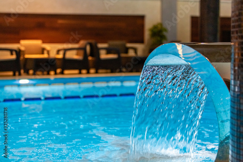 Modern blue on light backdrop. Water - swimming pool. Blue luxurious swimming pool. Swimming pool for luxury lifestyle design. Water - swimming pool. Luxury lifestyle. Natural pattern, luxury. Blue