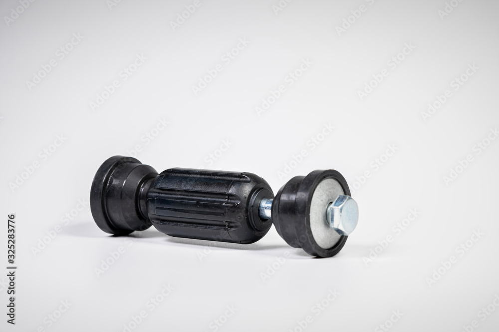 Car front suspension anti-roll bar mount. New tie rod on gray background Car front suspension anti-roll bar mount. New tie rod on gray background