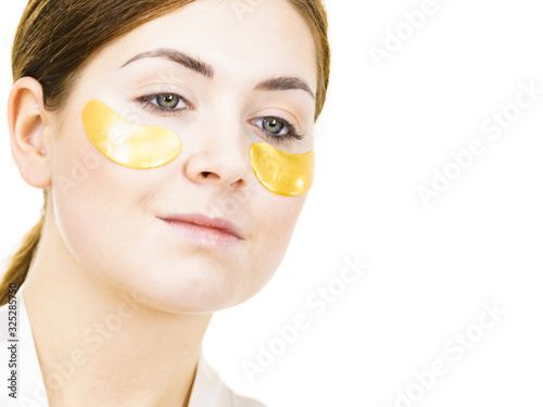 Woman with gold patches under eyes