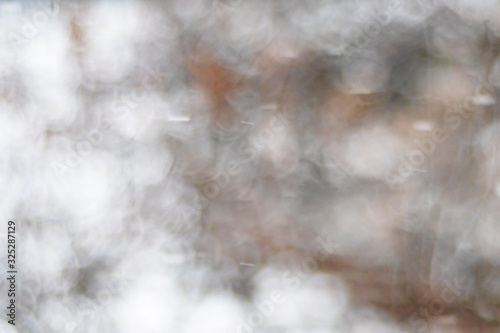 White and orange background blurred in bokeh on the theme of a snow forest
