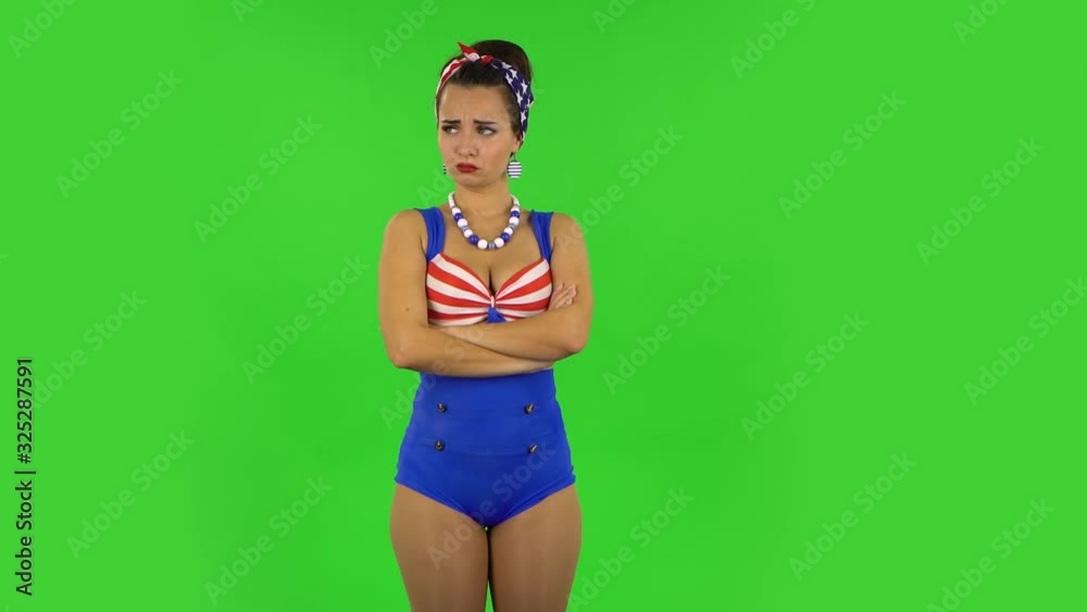 Beautiful girl in a swimsuit is very offended and looking away then smiling. Green screen Beautiful girl in a swimsuit is very offended and looking away then smiling. Green screen