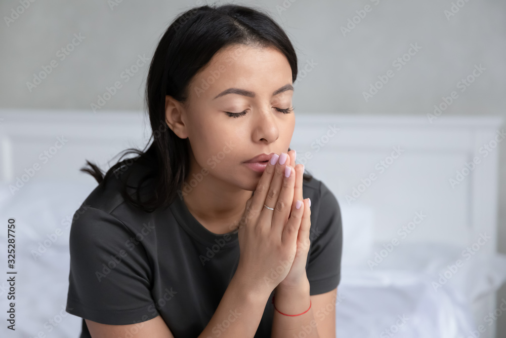 Religious african American woman praying in bedroom Religious african American woman praying in bedroom