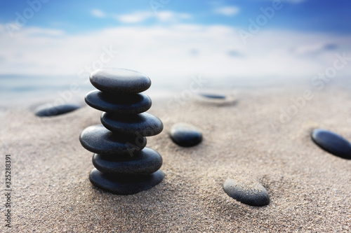 Balance stone with spa on blur beach and sea background