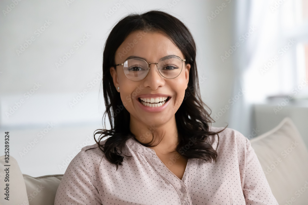 Headshot portrait of biracial woman relax on couch Headshot portrait of biracial woman relax on couch