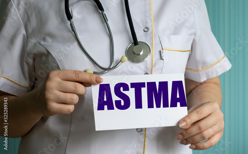 concept words astma in the hands of a doctor photo