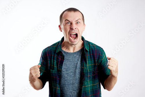 Fotografia Man in anger shouts, domestic violence, irritation, an angry expression on his f