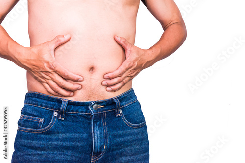 Overweight man with hand holding fat belly.Overweight man pinches the excess fat that he has around his waist.Isolated on white background. © Mohwet