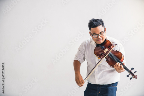 Symphony orchestra on white background, hands playing violin. Male violinist playing classical music on violin. Talented violinist and classical music player solo performance. photo
